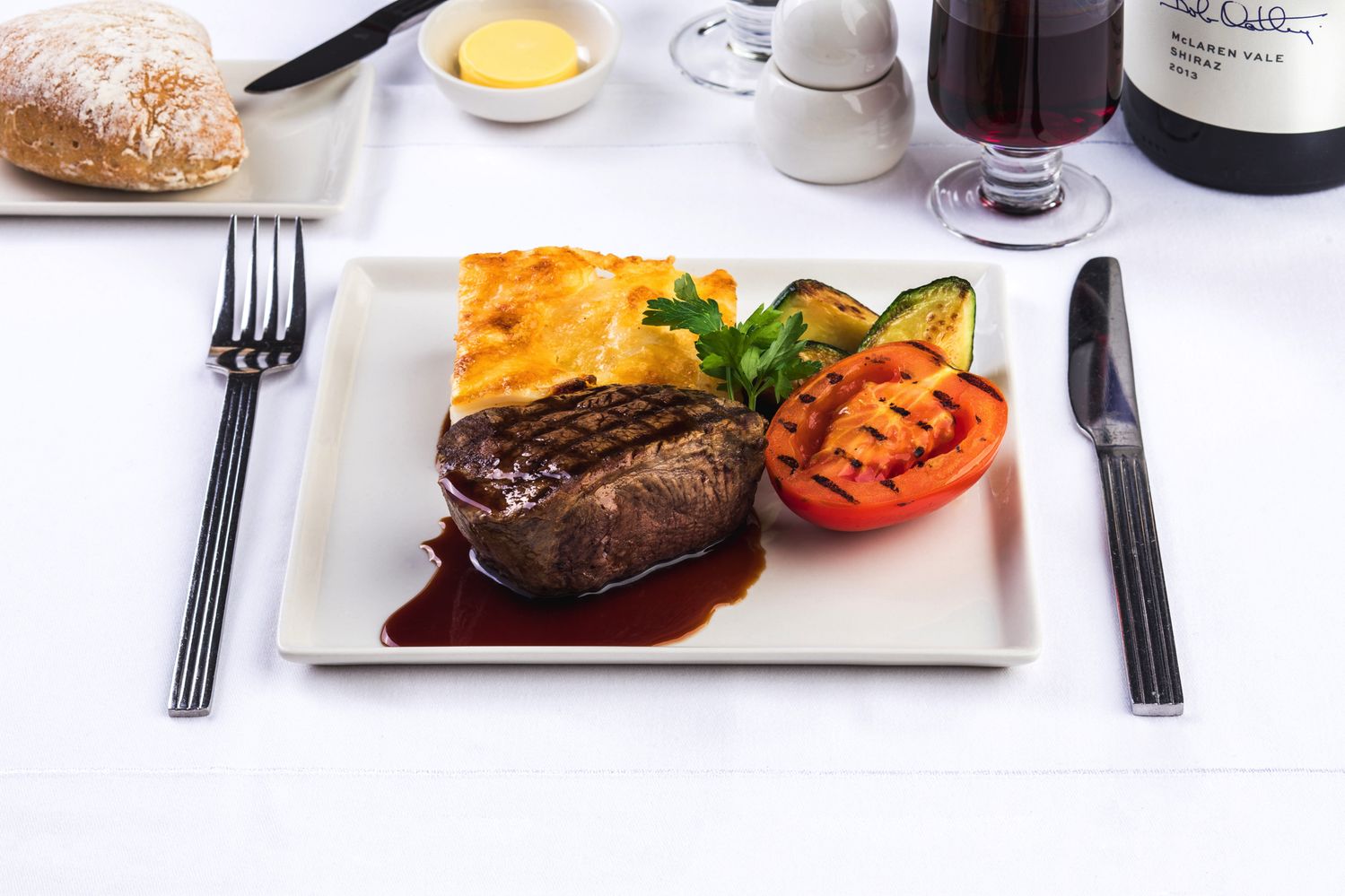 Grilled beef fllet: Grilled Australian beef fllet with a red wine veal jus reduction, slow baked potato and cream gratin, served with a selection of grilled vegetables.